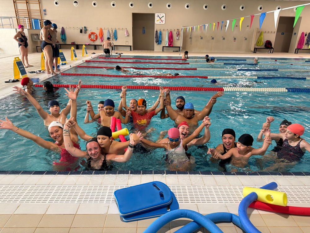 Campers celebrating together in the pool at the aquathon