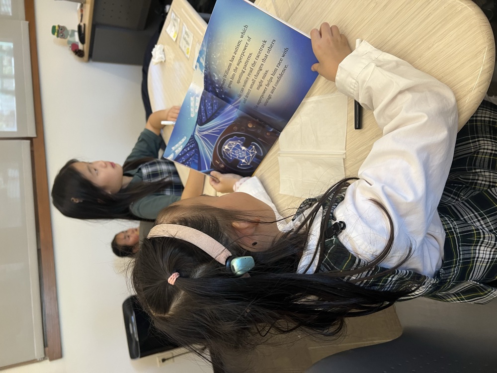 Children reading a Tesserae Minds storybook together at a table
