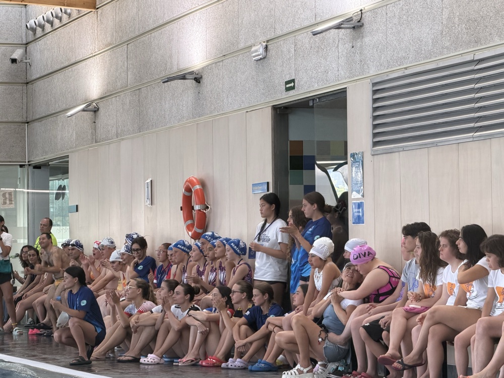 Campers and counselors gathered poolside at a summer camp
