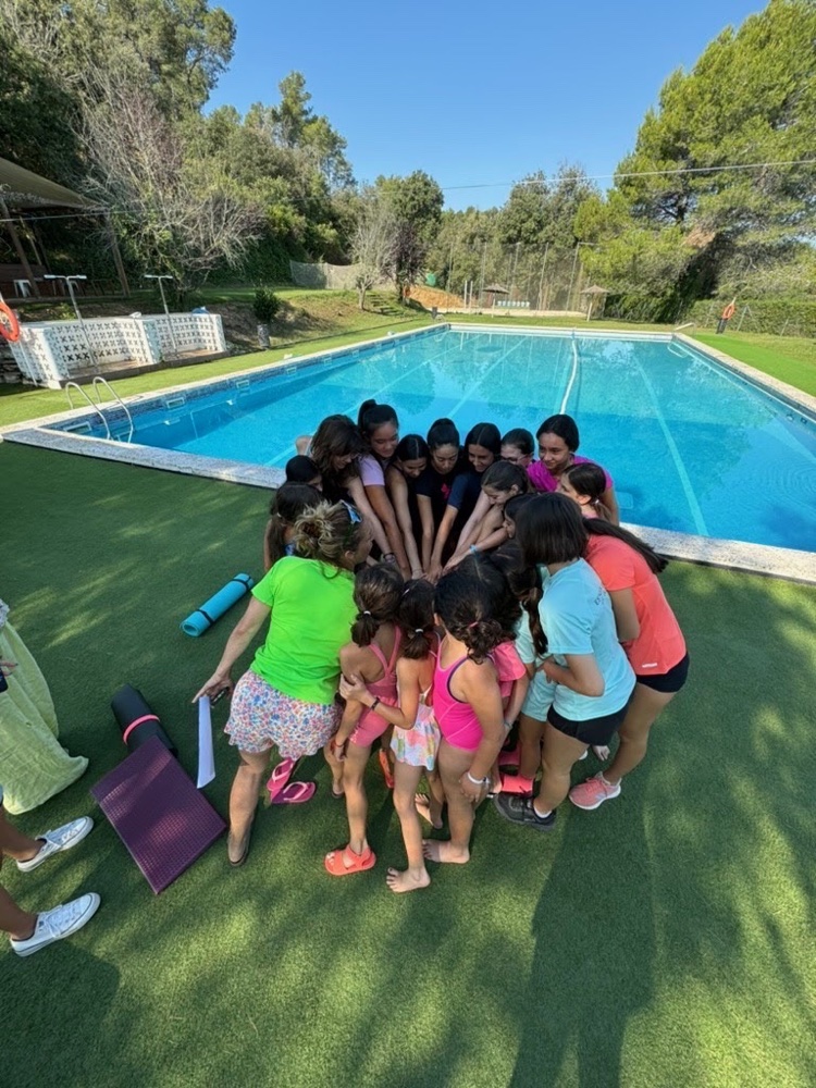 Campers huddled together poolside at camp
